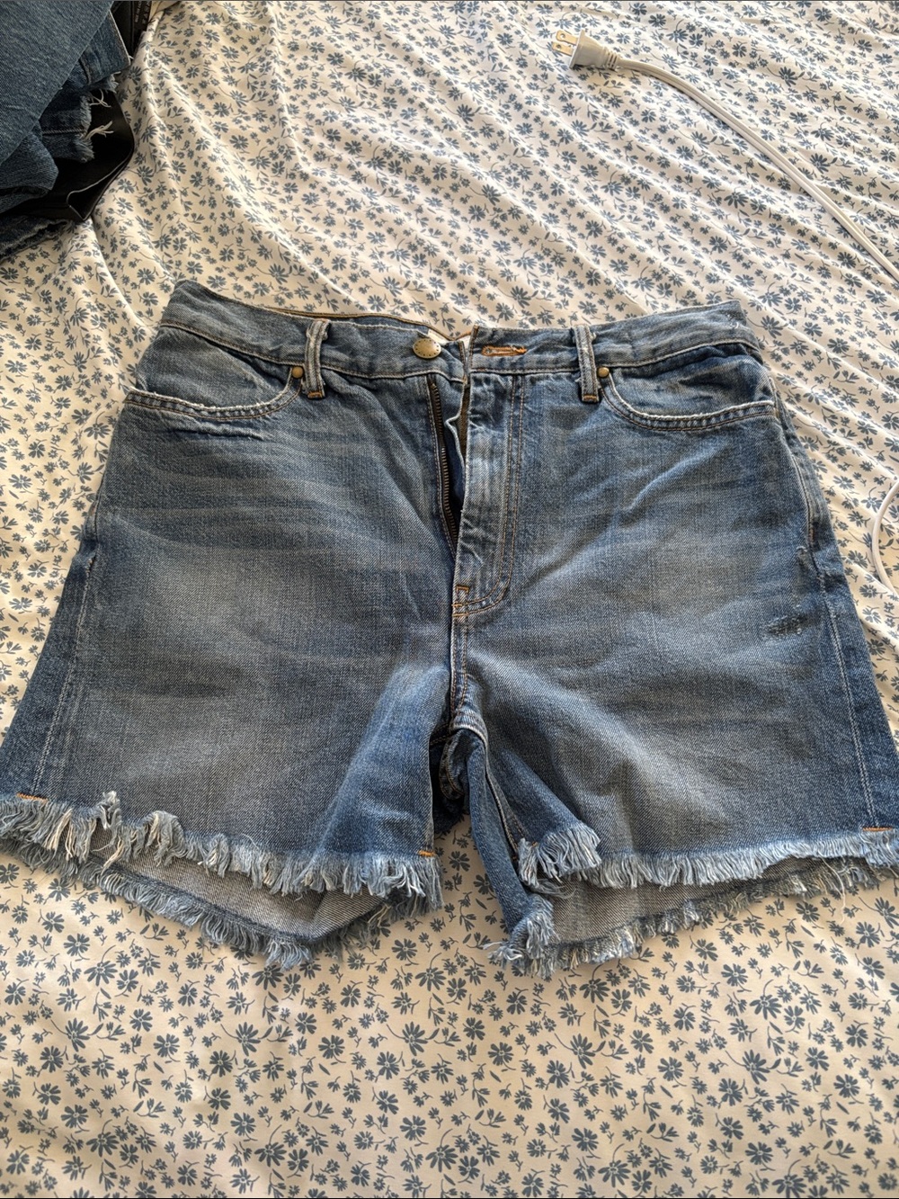 THE GREAT. Distressed Light Blue Denim Cutoff Shorts